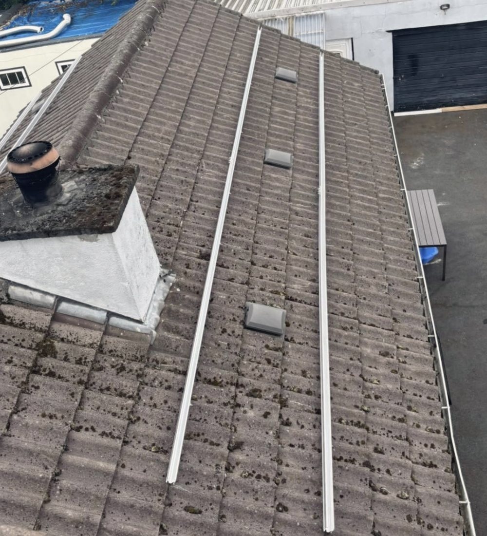 Two mounting rails running down the tiled roof, fixed and squared, ready for the panels