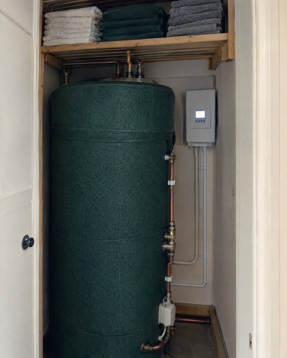 A hot water cylinder with a solar diverter beside it